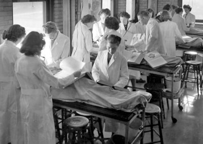 Women physicians dissecting cadaver circa 1950